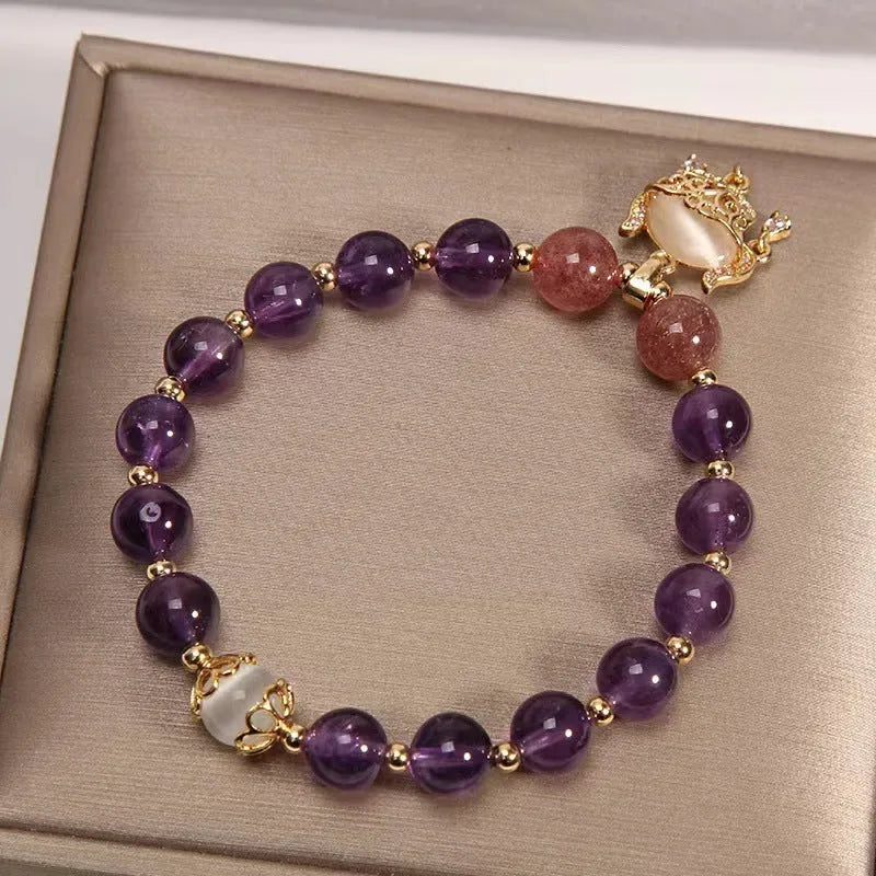Women's handmade copper longevity lock bracelet with natural amethyst accents and safety lock charm