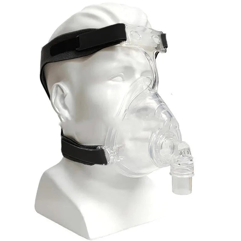 Transparent silicone CPAP breathing mask with headband and PC elbow adapters on a white background.