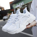 Women's white and black mesh casual sports shoes with thick sole, buckle closure, and round toe.