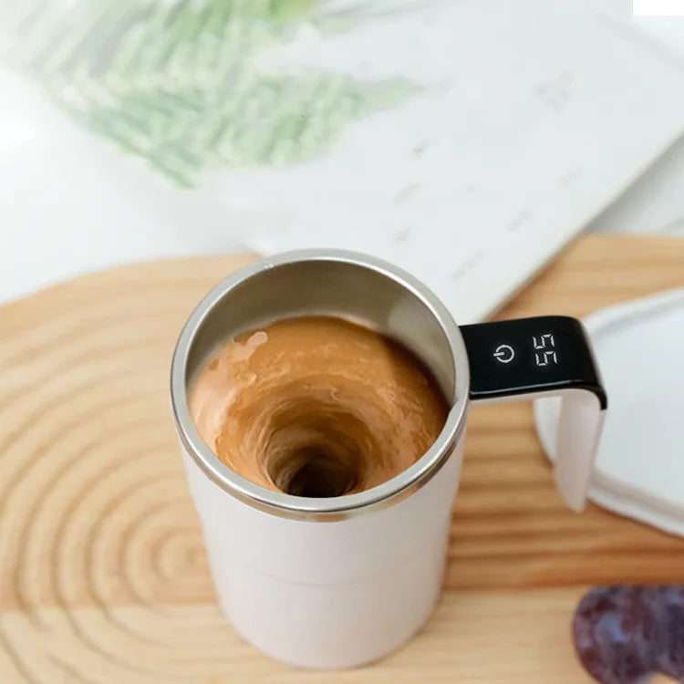 White electric coffee mug with LCD display showing temperature and magnetic stirring base