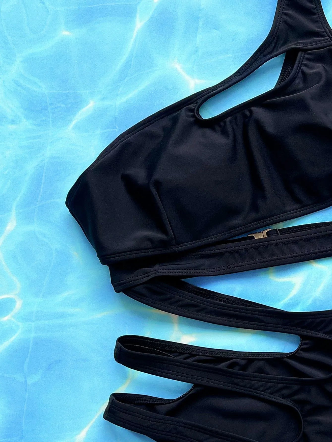 Black women's one-piece swimsuit with hollow out strap design showing front view