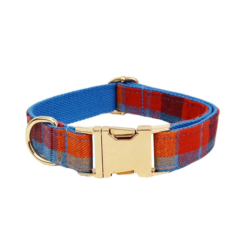 Blue plaid cloth dog collar with attached hand holding rope on adjustable size settings