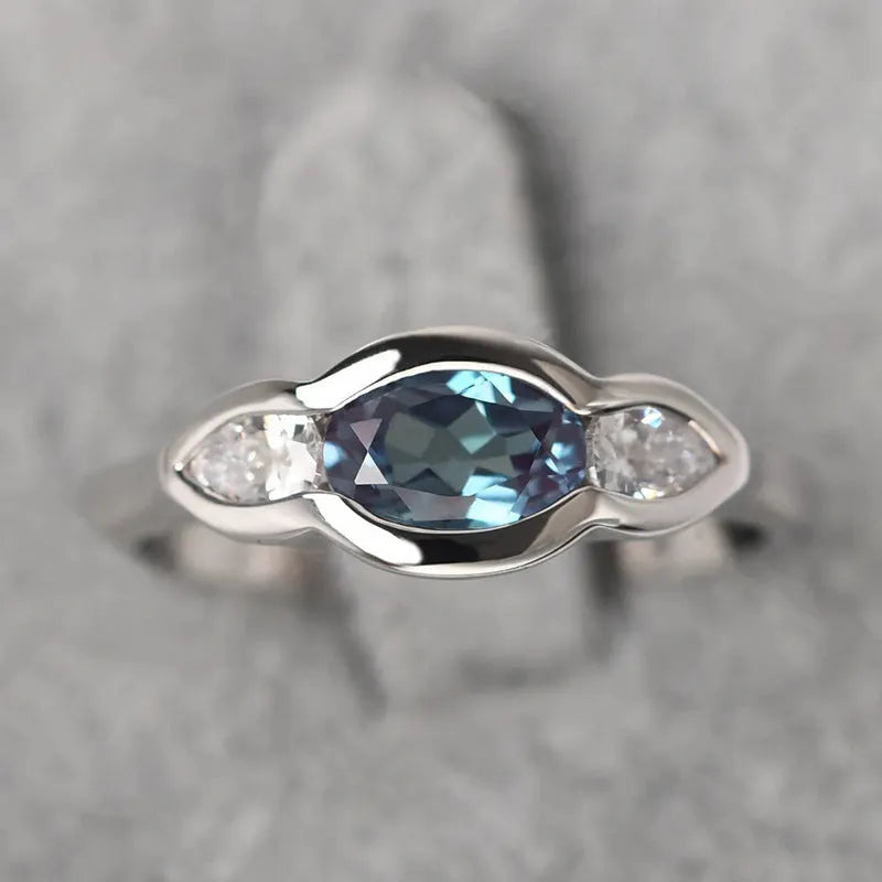 Geometric ellipse ring with zircon stones in white gold finish showing elliptical shape