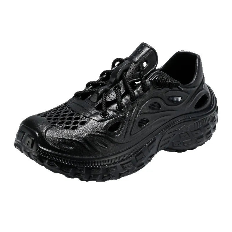 Men's black perforated EVA sandals with a thick sole and covered heel on a wooden deck.