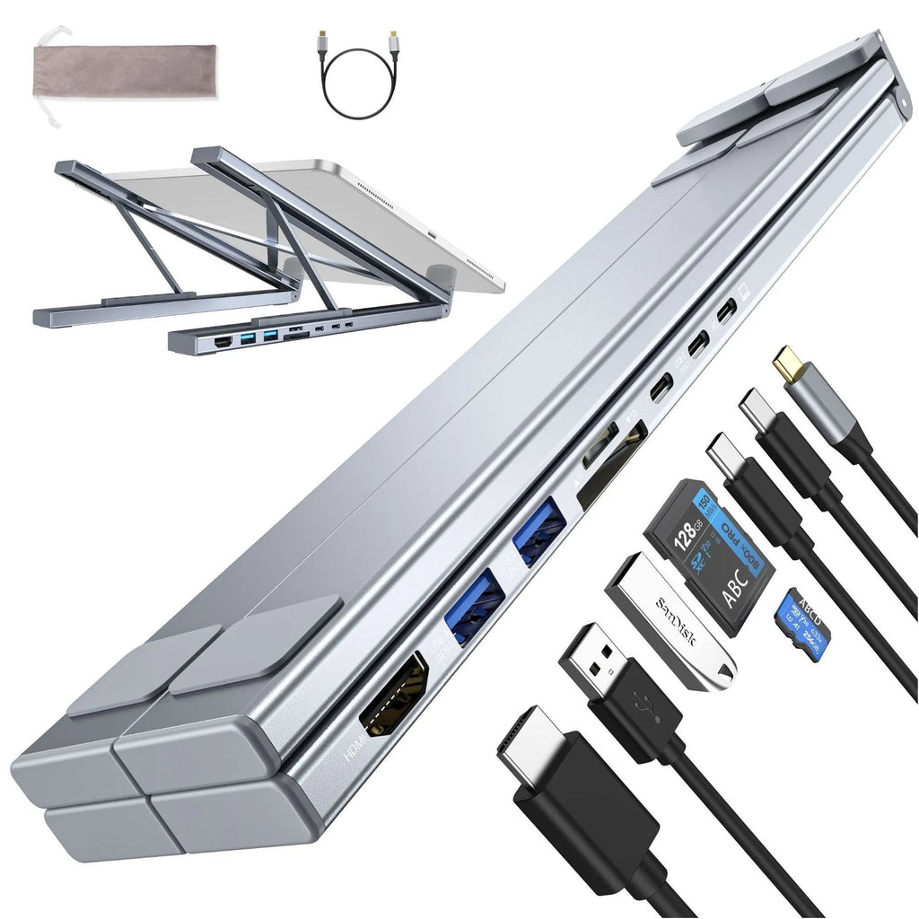 Aluminium folding laptop stand with built-in multi-port docking hub on a desk.