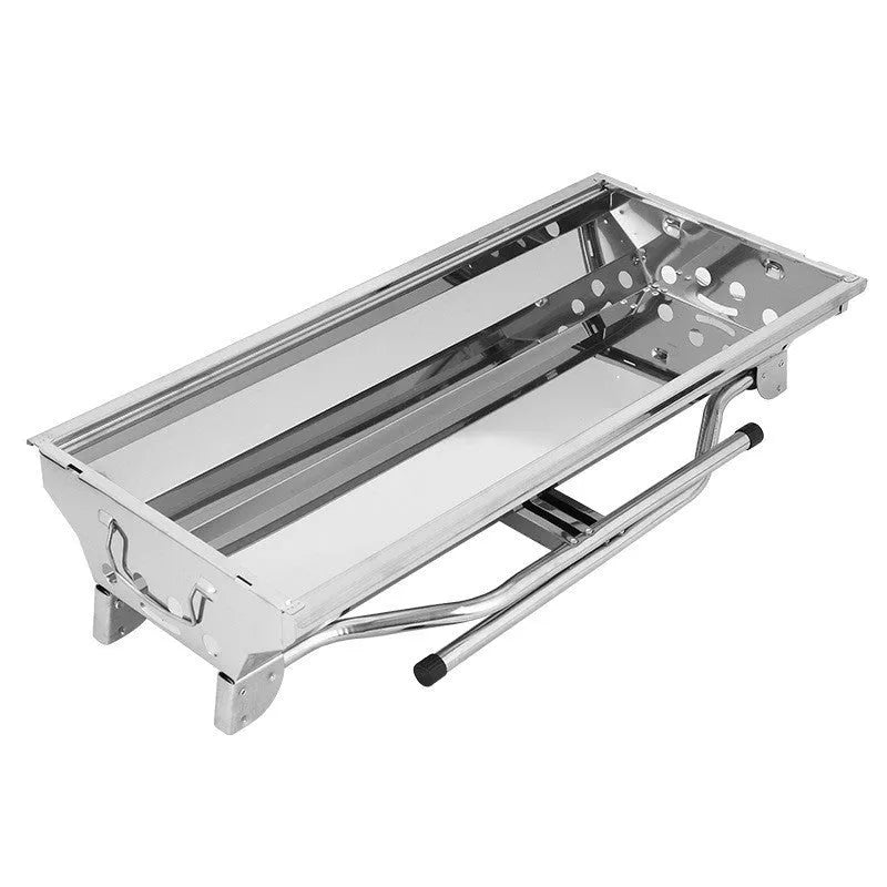 Stainless steel folding portable barbecue grill set up outdoors.