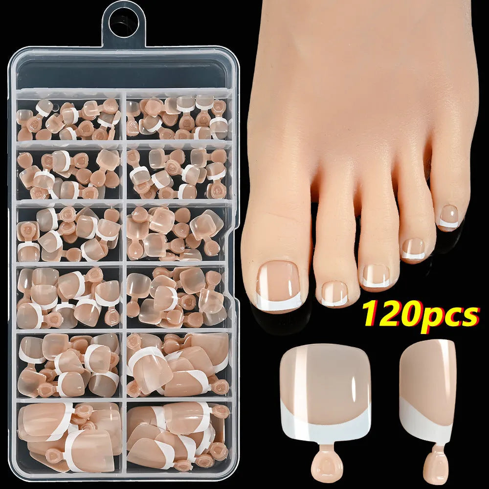 120 piece set of nude French white tip artificial toenails in nine shades, showing square short shape.