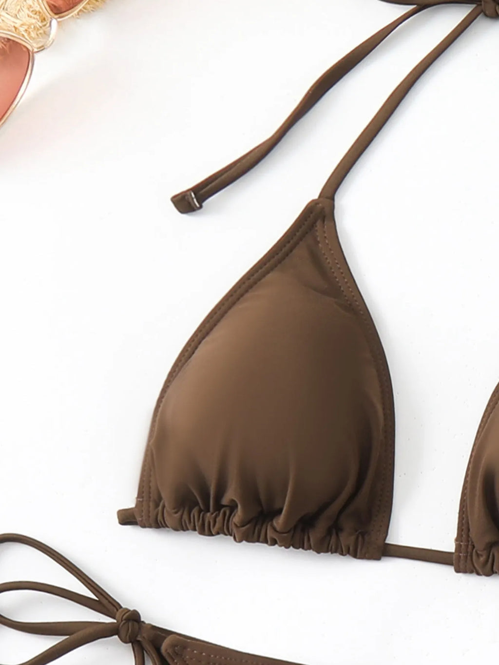 Brown women's three-piece swimsuit bikini set with bra, shorts, and blouse on mannequin