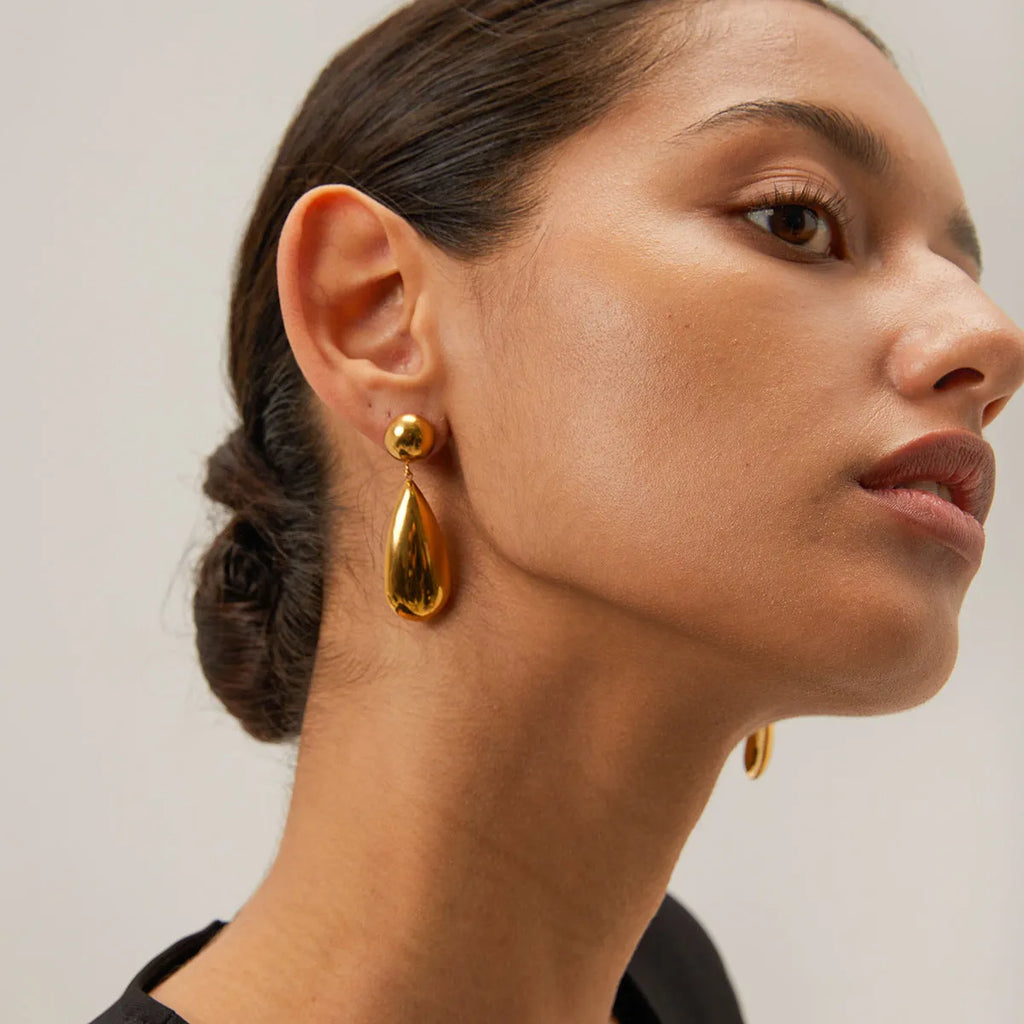 Gold stainless steel water drop shaped hemisphere pendant earrings for women.