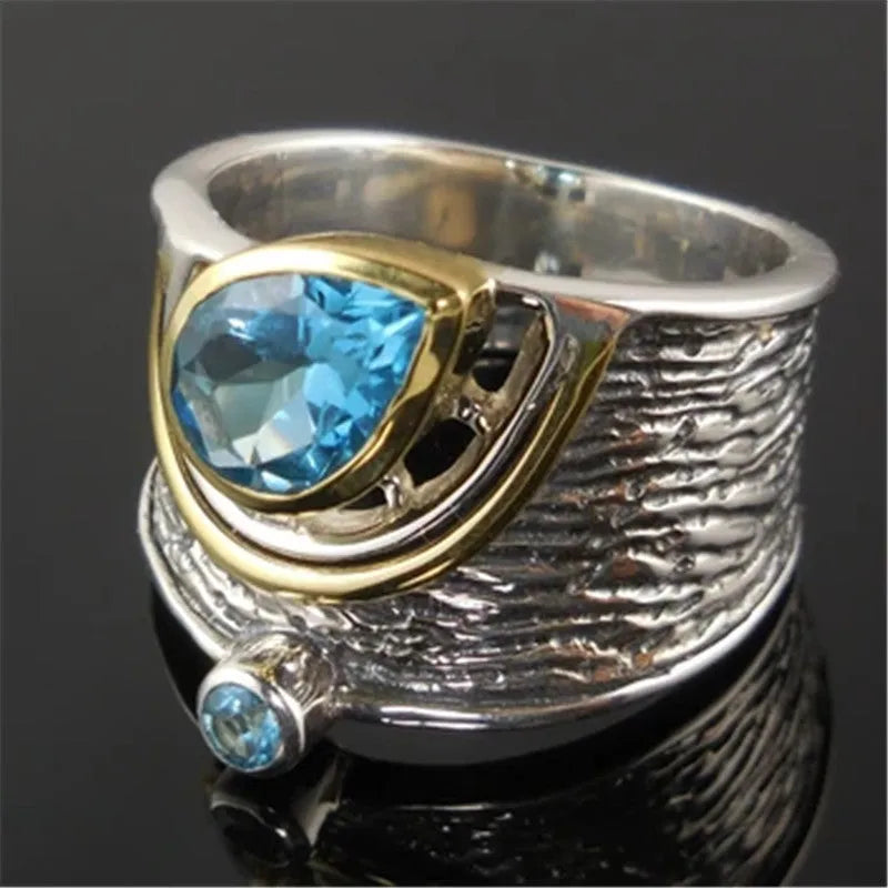 Women's blue zircon drop shape alloy ring with Chinese style design on a white background.