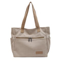 Canvas shoulder bag for women in khaki with stitching detail, open front pocket, and double shoulder straps