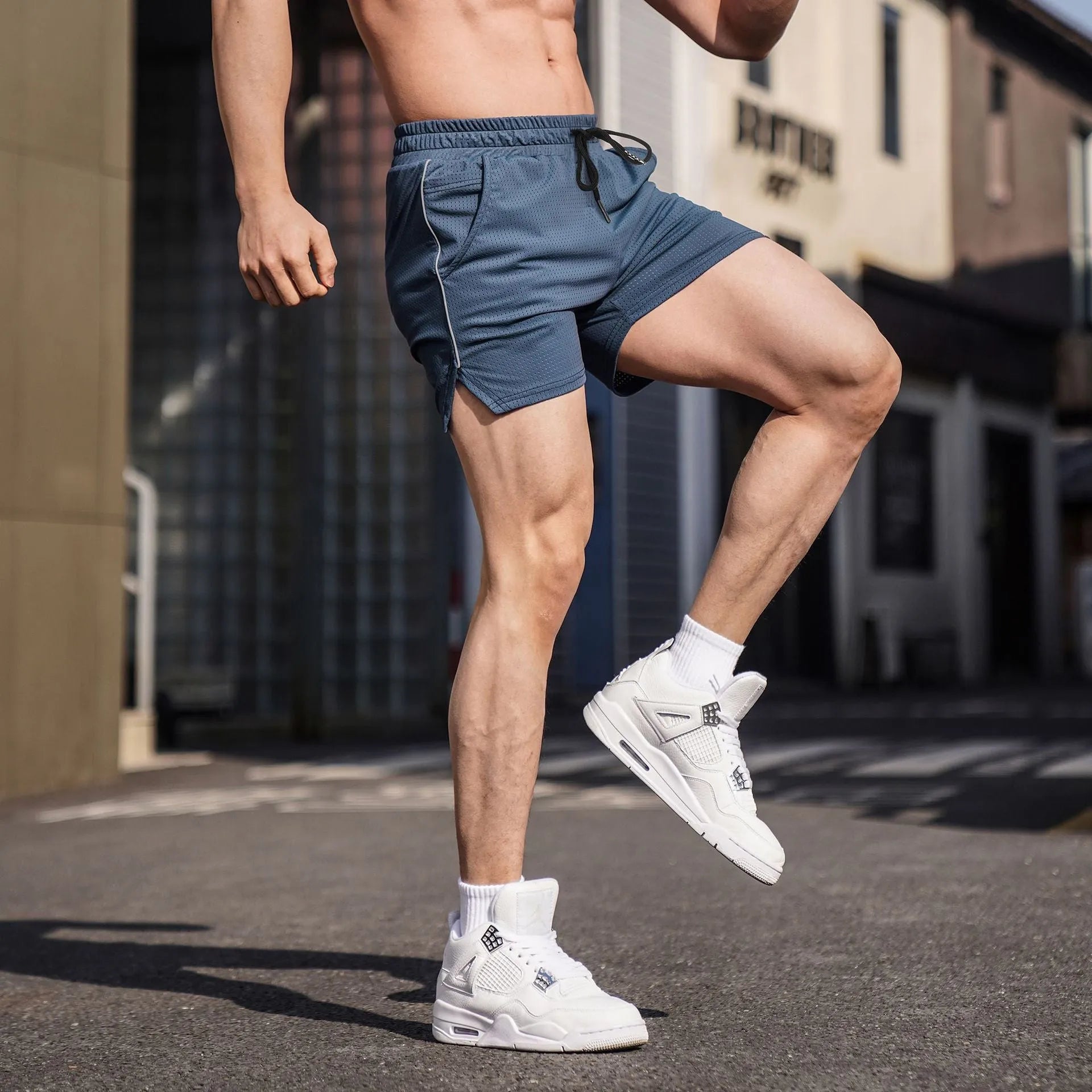 Men's straight-leg sports shorts in polyester, shown in black, grey, navy blue, and red colours.