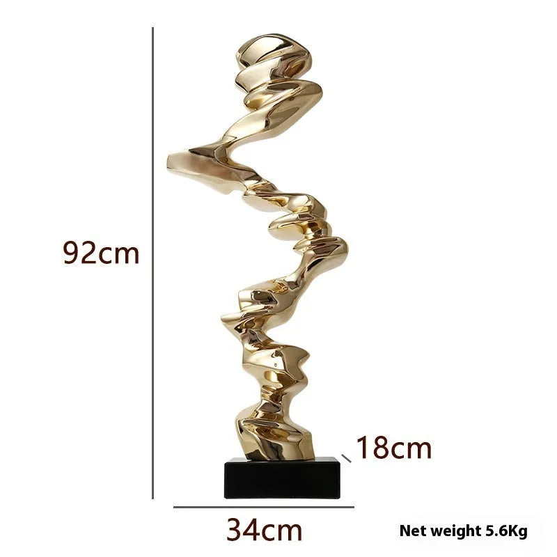 Minimalist abstract still life ornament in natural resin on a shelf, shown in bright gold finish.