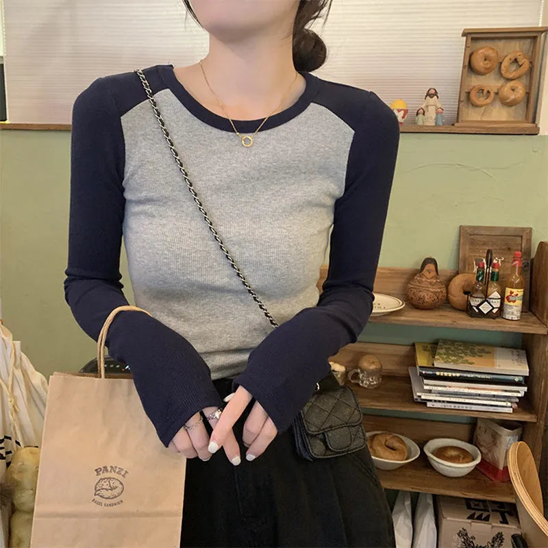 Dark blue women's oversized viscose top with embroidery and long princess sleeves on a hanger.