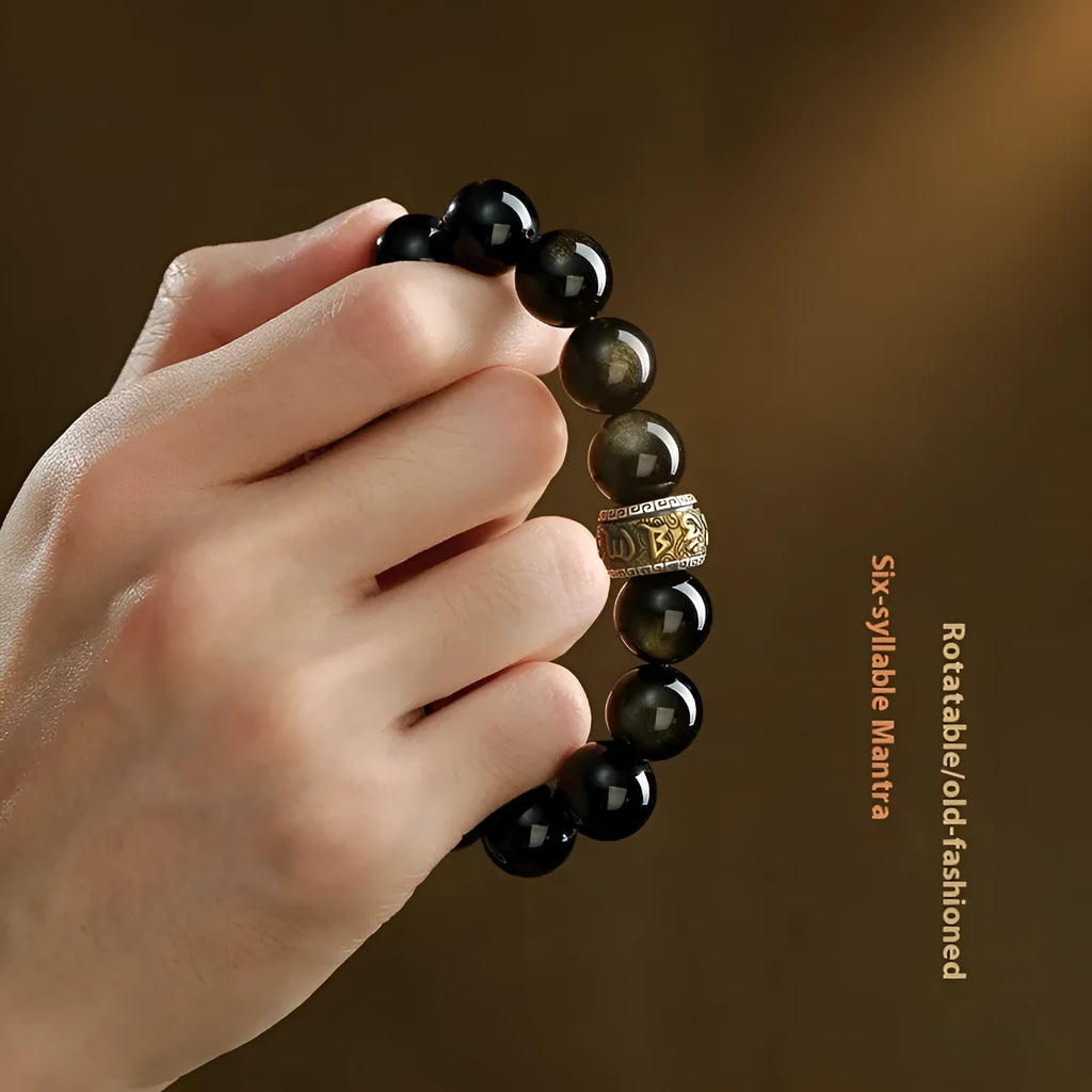 Carved cinnabar beads bracelet with gold obsidian animal zodiac design on a gift box.