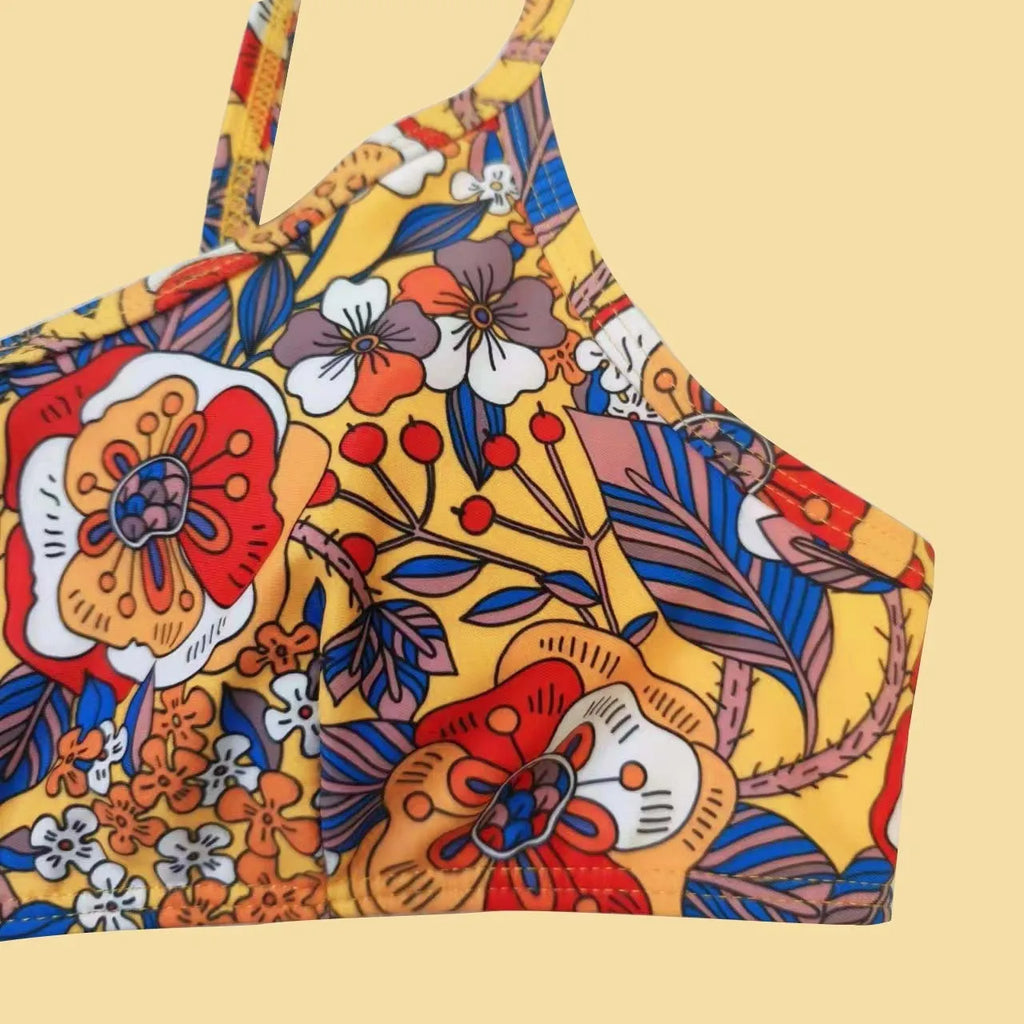 Plus size women's floral print strap bikini swimsuit two-piece set on a mannequin