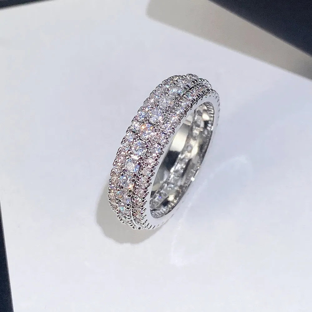 Geometric copper ring with a triangular zircon stone inlay, shown in white gold finish.