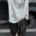 Dirty print pattern on a solid colour loose fit Korean style short sleeve t-shirt.