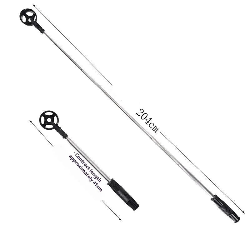 Black stainless steel retractable golf ball retriever with plastic head on golf course