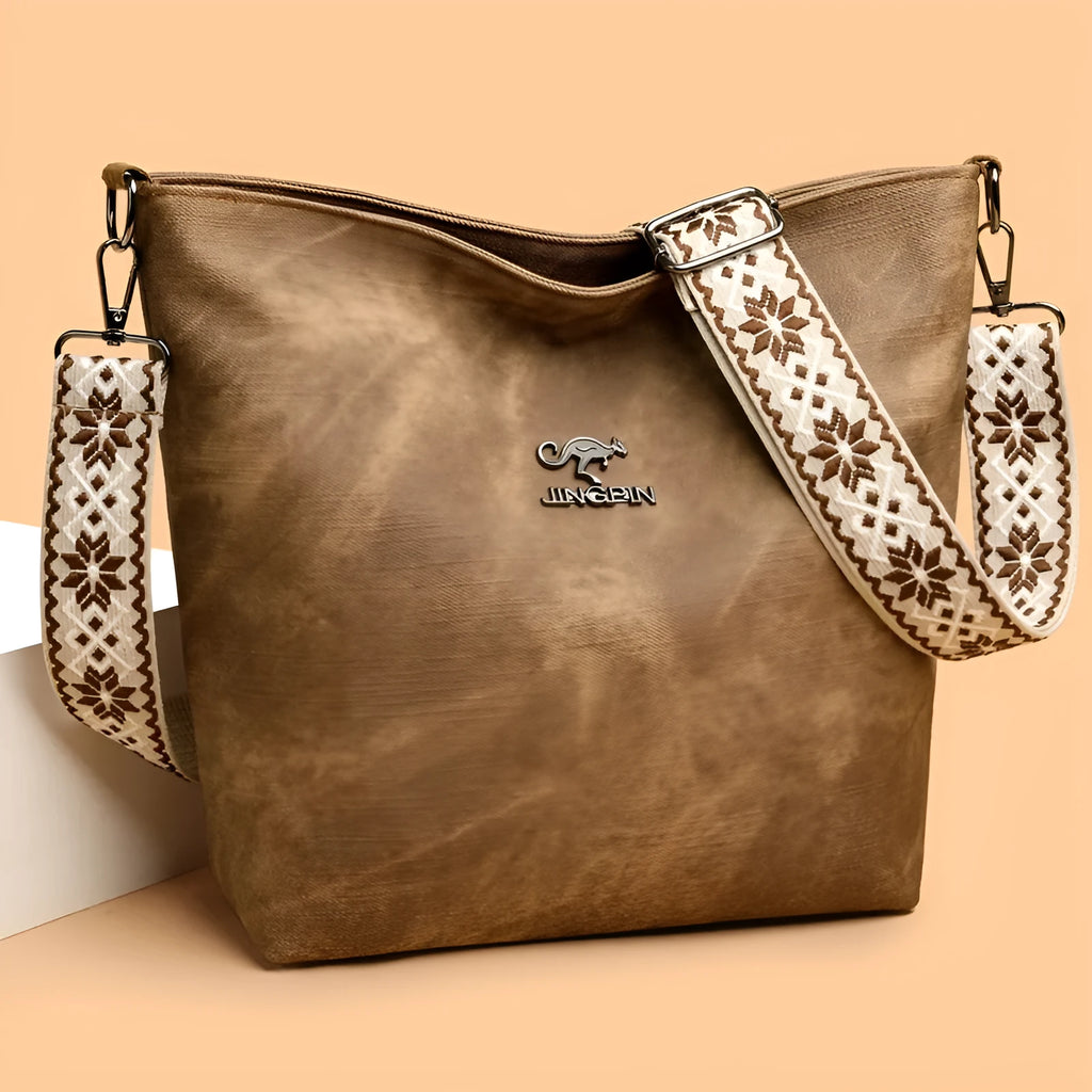 Soft grey PU crossbody bag with a large main compartment and adjustable shoulder strap