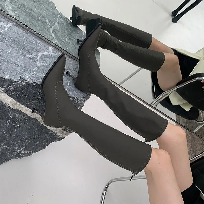 Black pointed toe women's ankle boots with a stiletto heel and a back zipper closure.