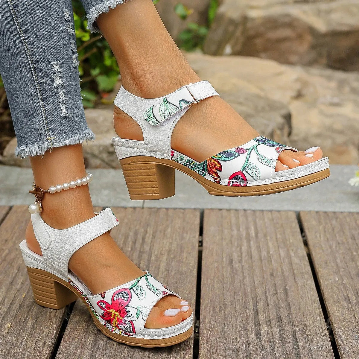 White women's high heel sandals with velcro buckle closure showing rubber sole