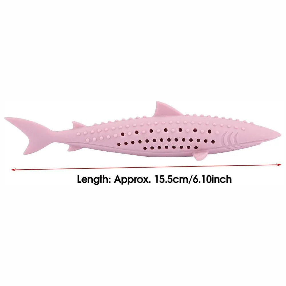 Green dolphin-shaped silicone cat chew toy with side holes on a white background