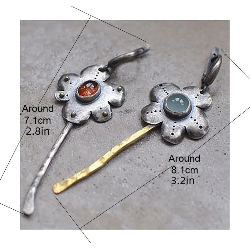 A pair of long retro earrings with asymmetric geometric flower shapes in a two-tone electroplated finish.