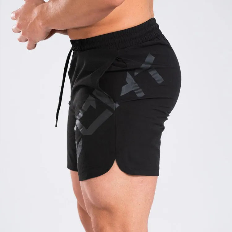 Men's black quick-drying nylon blend training shorts with elastic waist, shown in knee-length sports style.