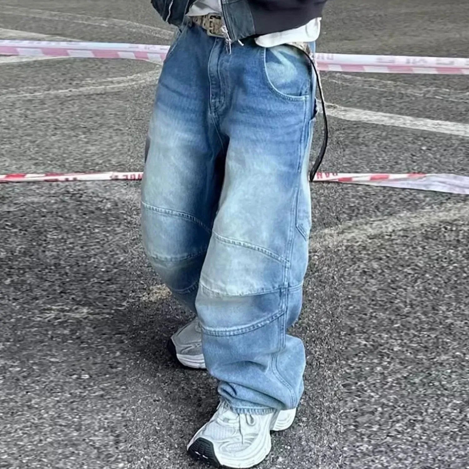 Men's light blue baggy jeans with front pleats and a straight-leg fit on a plain background.