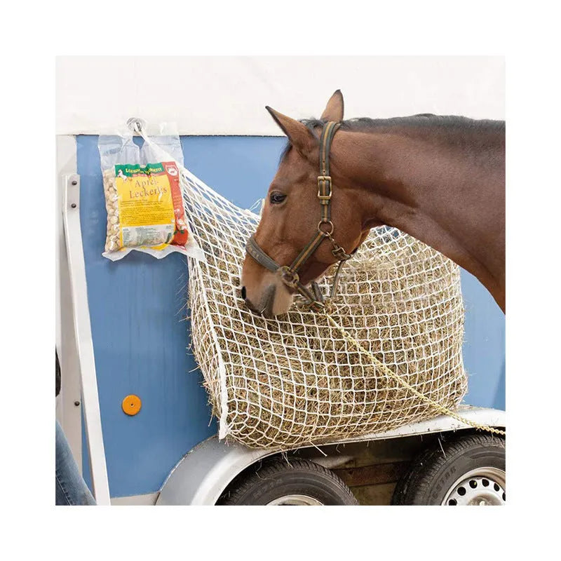 Black woven grid horse feeding bag hanging, showing size options for cattle, horses and sheep.