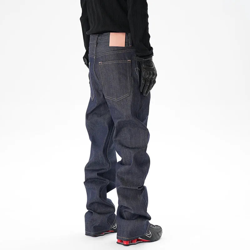 A pair of dark blue loose-fit straight leg jeans on a neutral background.
