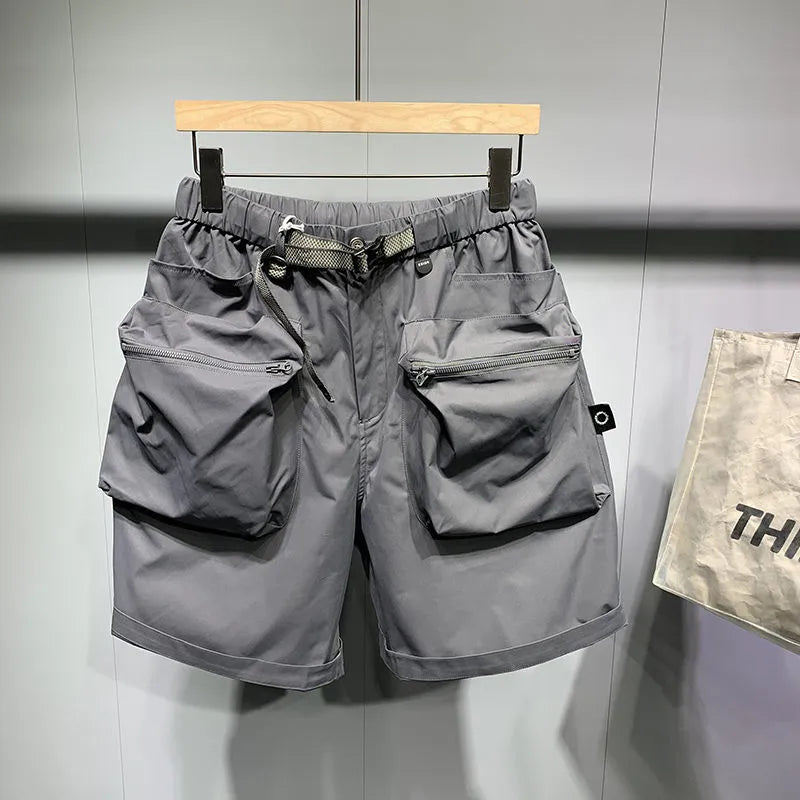 Men's large size loose fitting black shorts with pockets and straight leg hem.