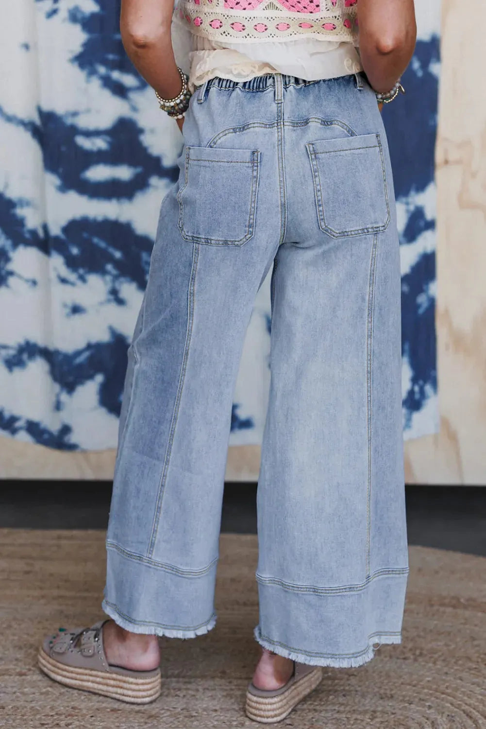 Beau blue wide leg denim trousers with drawstring seam detailing and raw hem finishing