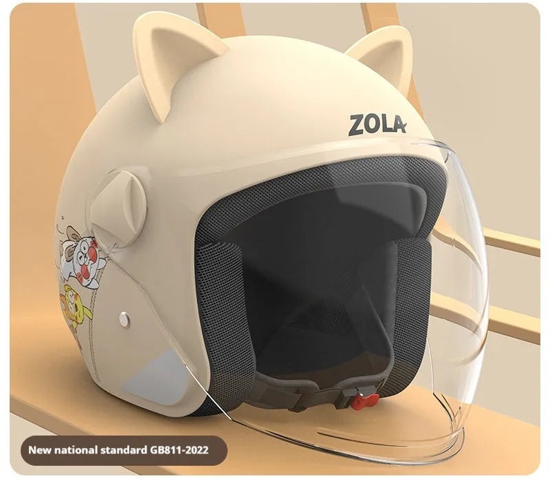 Blue winter electric bike helmet with anti-fog visor and a detached grey scarf on a table.
