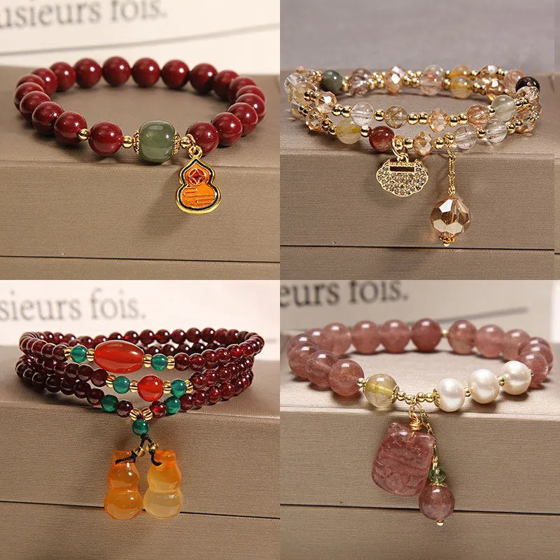 Women's multi-layer crystal bracelet with natural garnet, strawberry quartz pendants, and jinsi jade beads in assorted colours.
