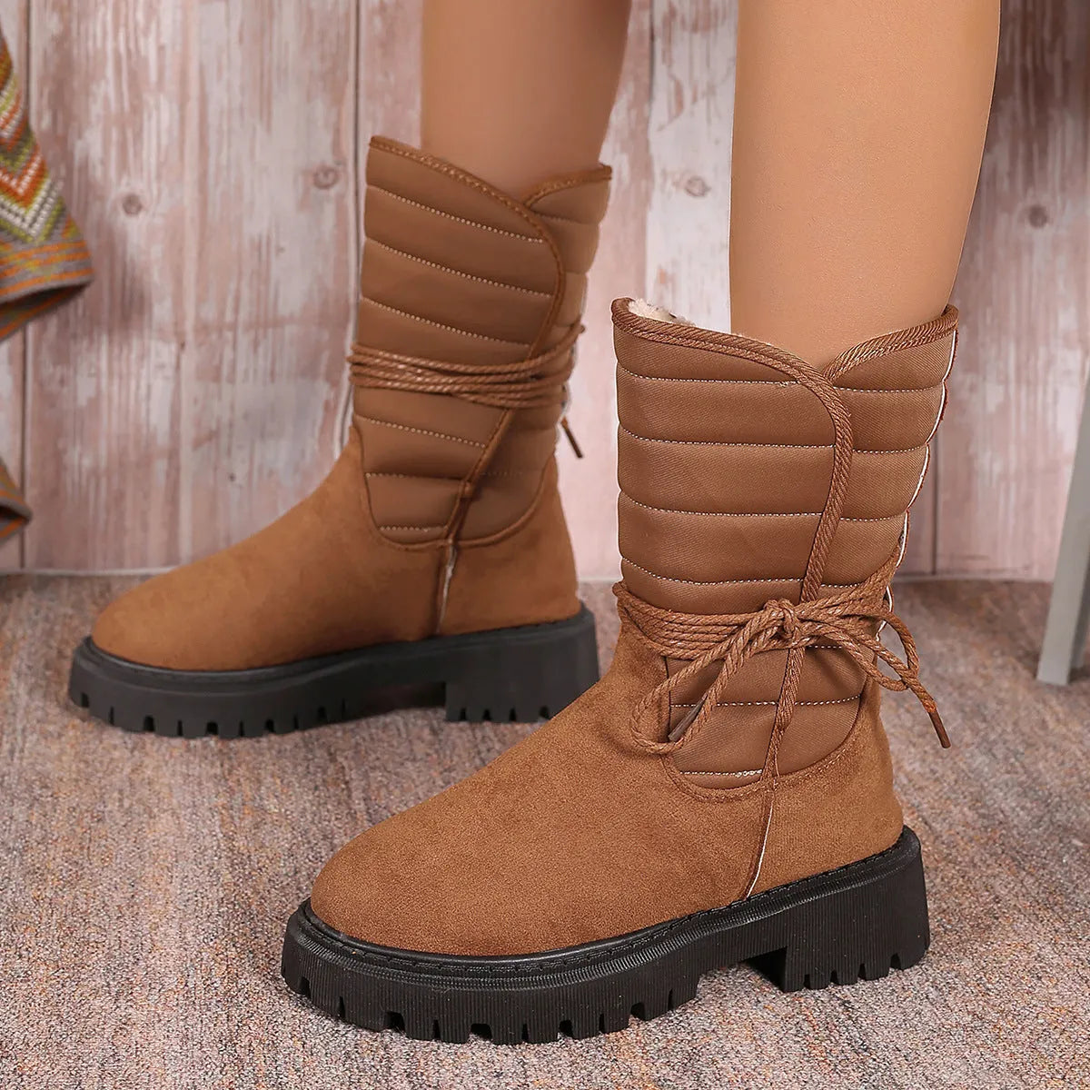 Women's black suede chunky heel mid-calf snow boot with lace-up front and fleece lining.