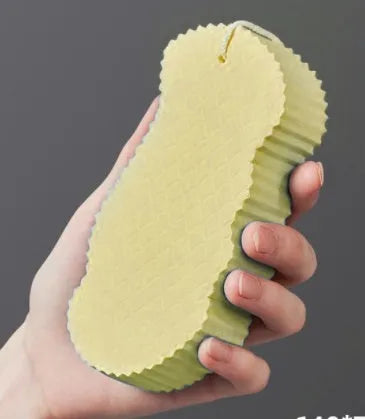 White 3D fish scale pattern bath sponge ball for gentle body exfoliation in the shower.