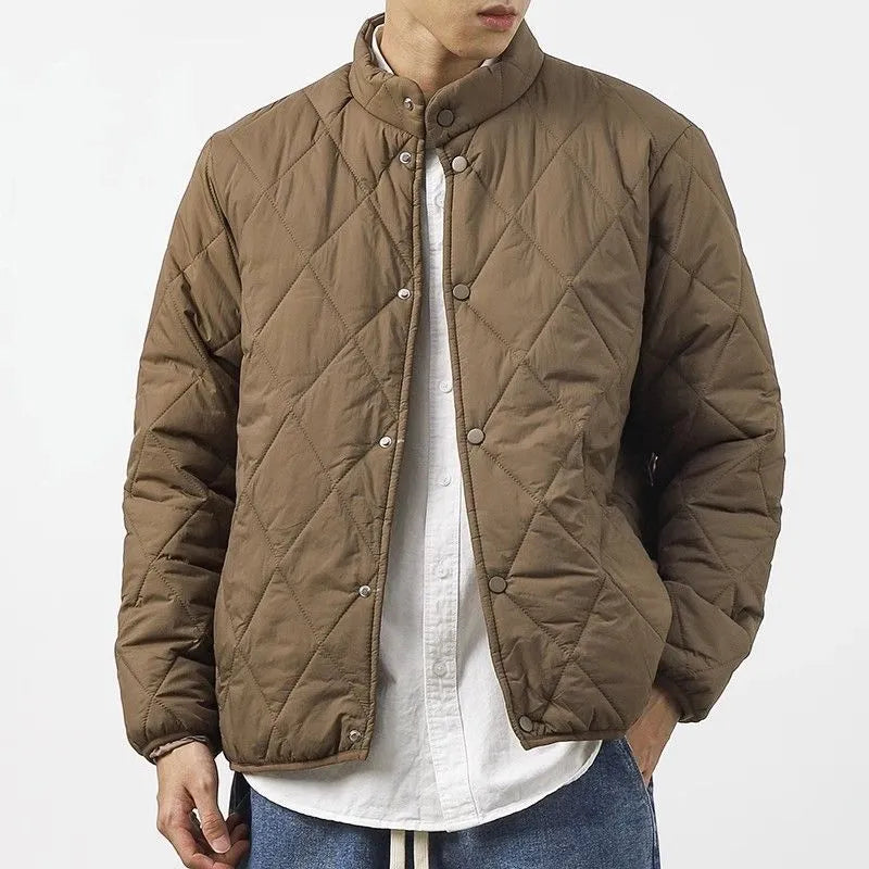 Men's black diamond lattice quilted winter jacket with extended length showing loose fit design