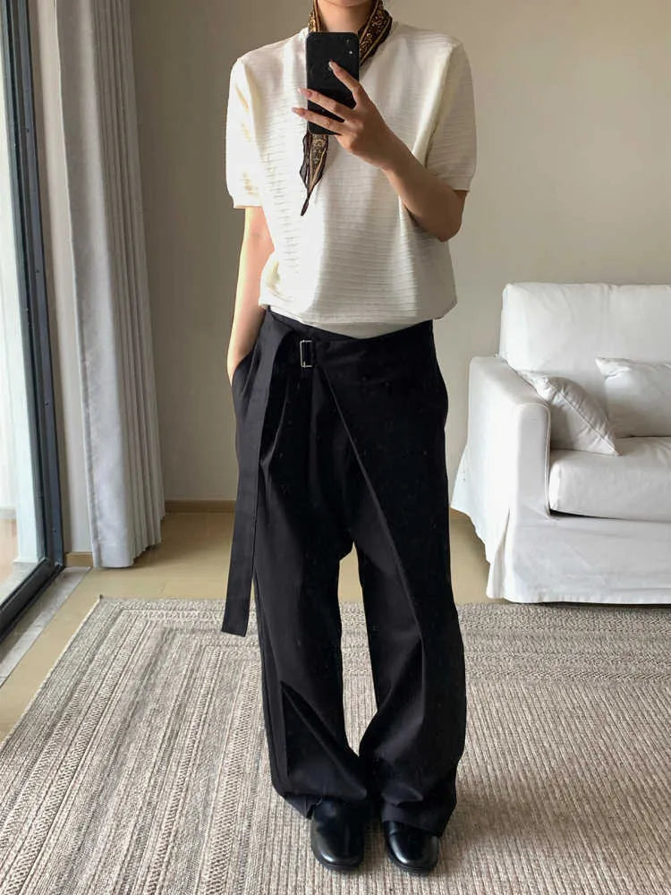 Black straight-leg trousers with a single pleat and adjustable waistband, made from a Tencel and cotton blend fabric.