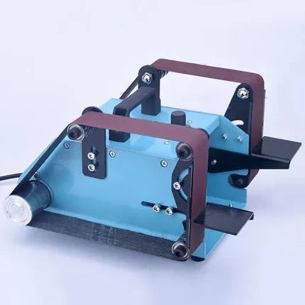 Blue desktop dual-axis belt sander on a workbench, a 750W sharpening and polishing tool.