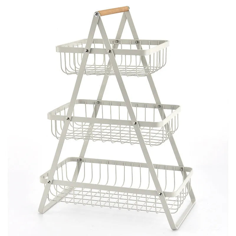 Black detachable double-layer iron fruit basket with a wooden carry handle on a tabletop.