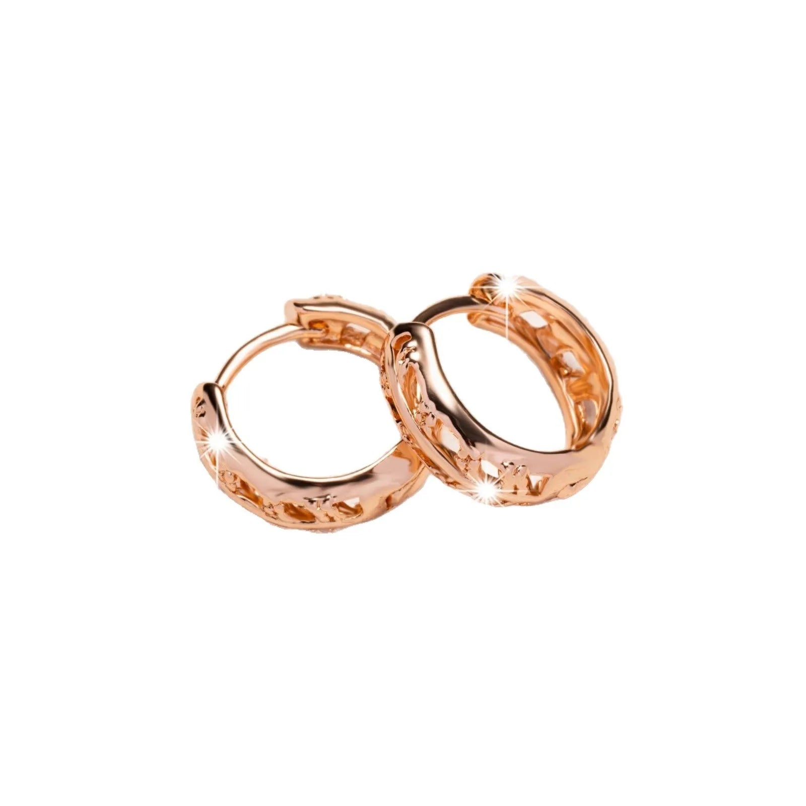 Rose gold coloured copper earrings with hollowed-out leaf and heart shapes.