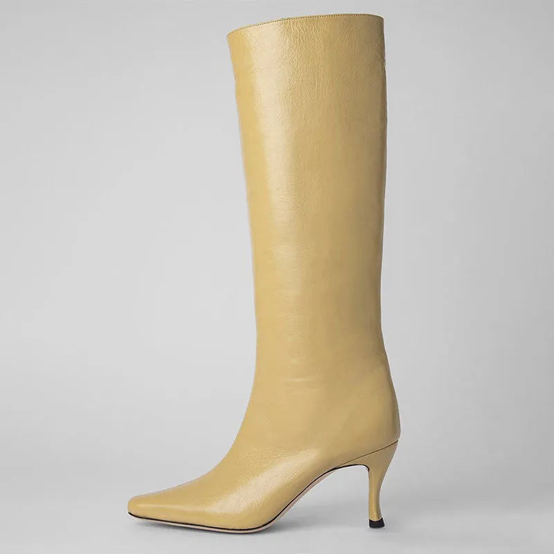 Women's black square toe cowboy boot with microfiber upper on a wooden background.