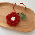 Hand crochet flower pendant made from plush wool in red or yellow colour
