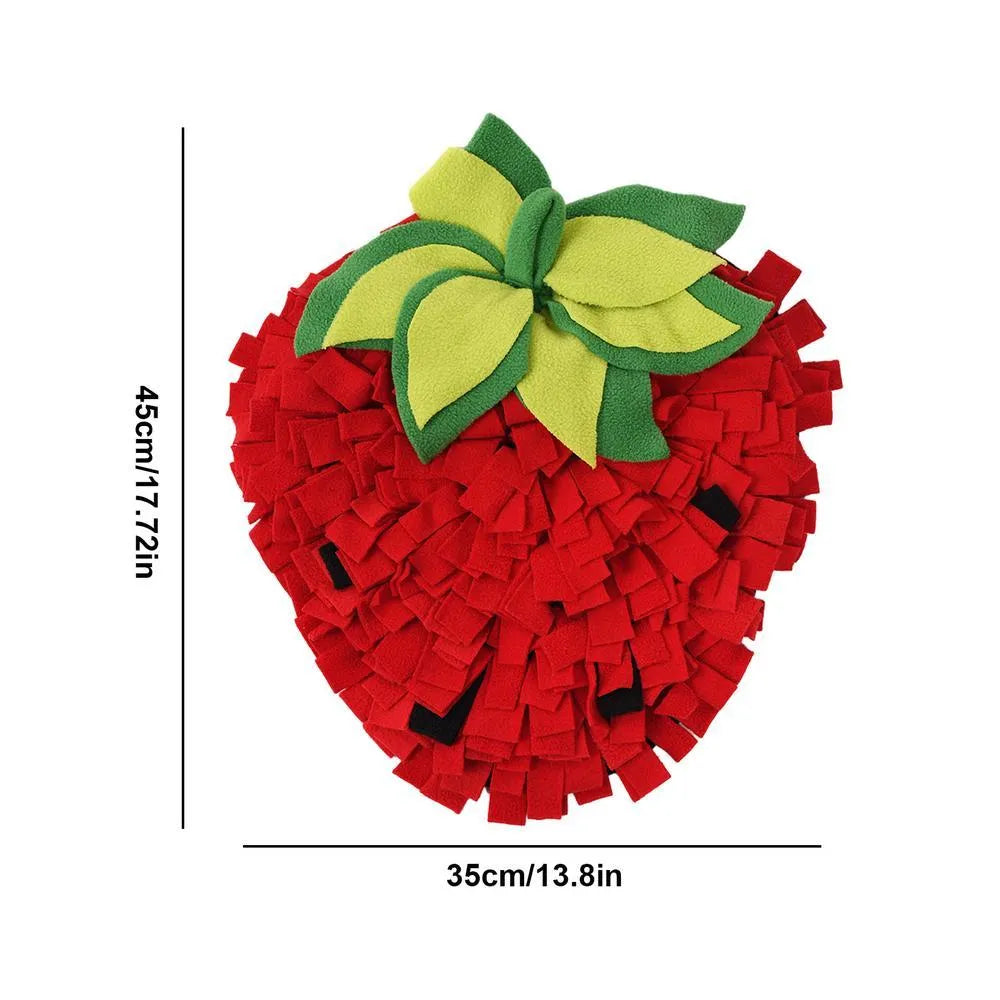 Red and green strawberry-shaped interactive slow feeder mat for pets on a floor.