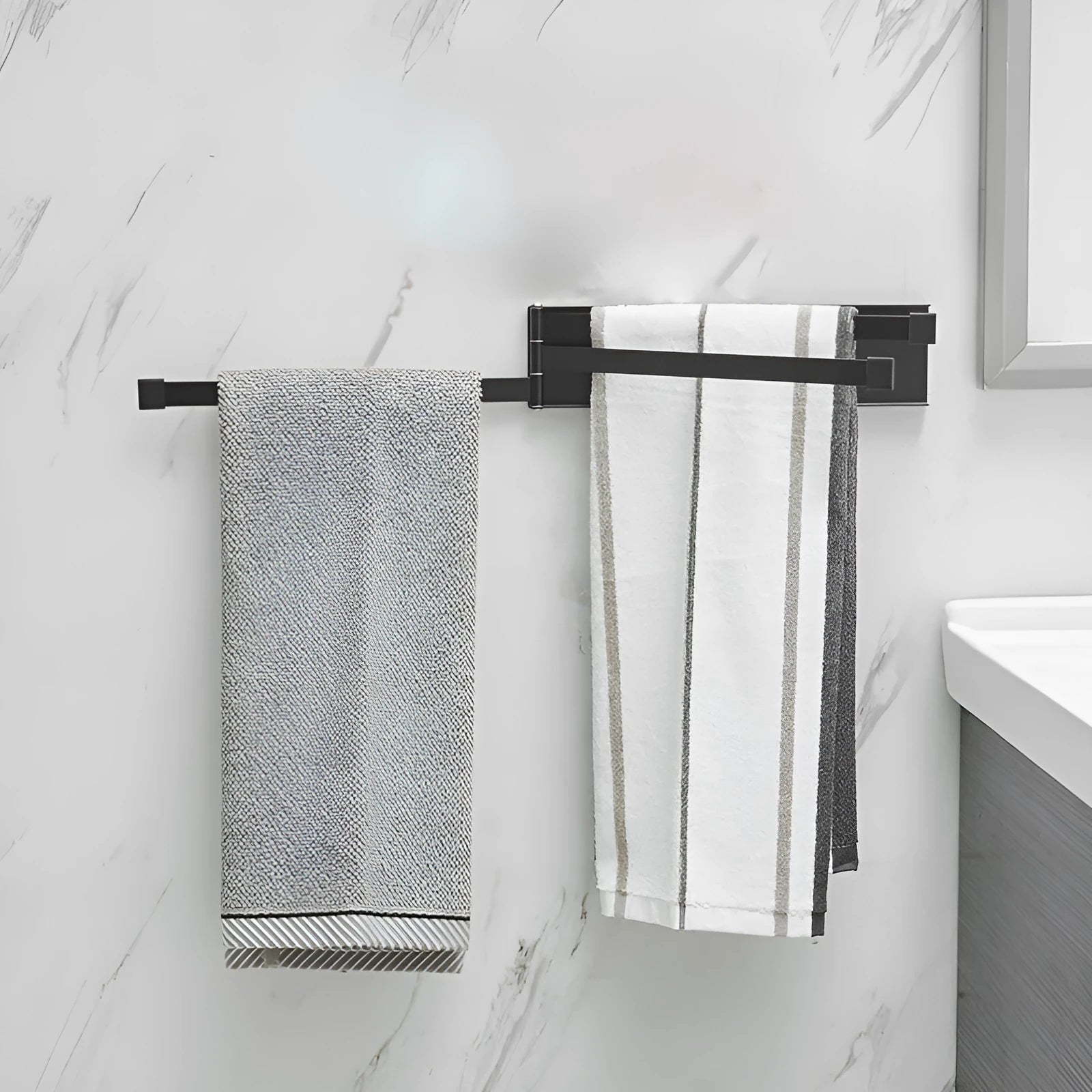 Nordic style black folding towel rack mounted on a bathroom wall