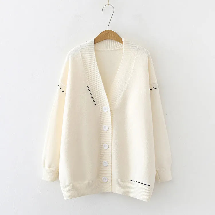 Women's loose-fit knitted cardigan top coat in black or white.