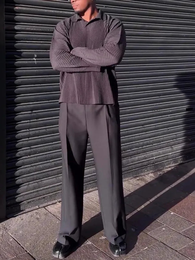 Men's black long-sleeved casual top with a pleated detail on the front.