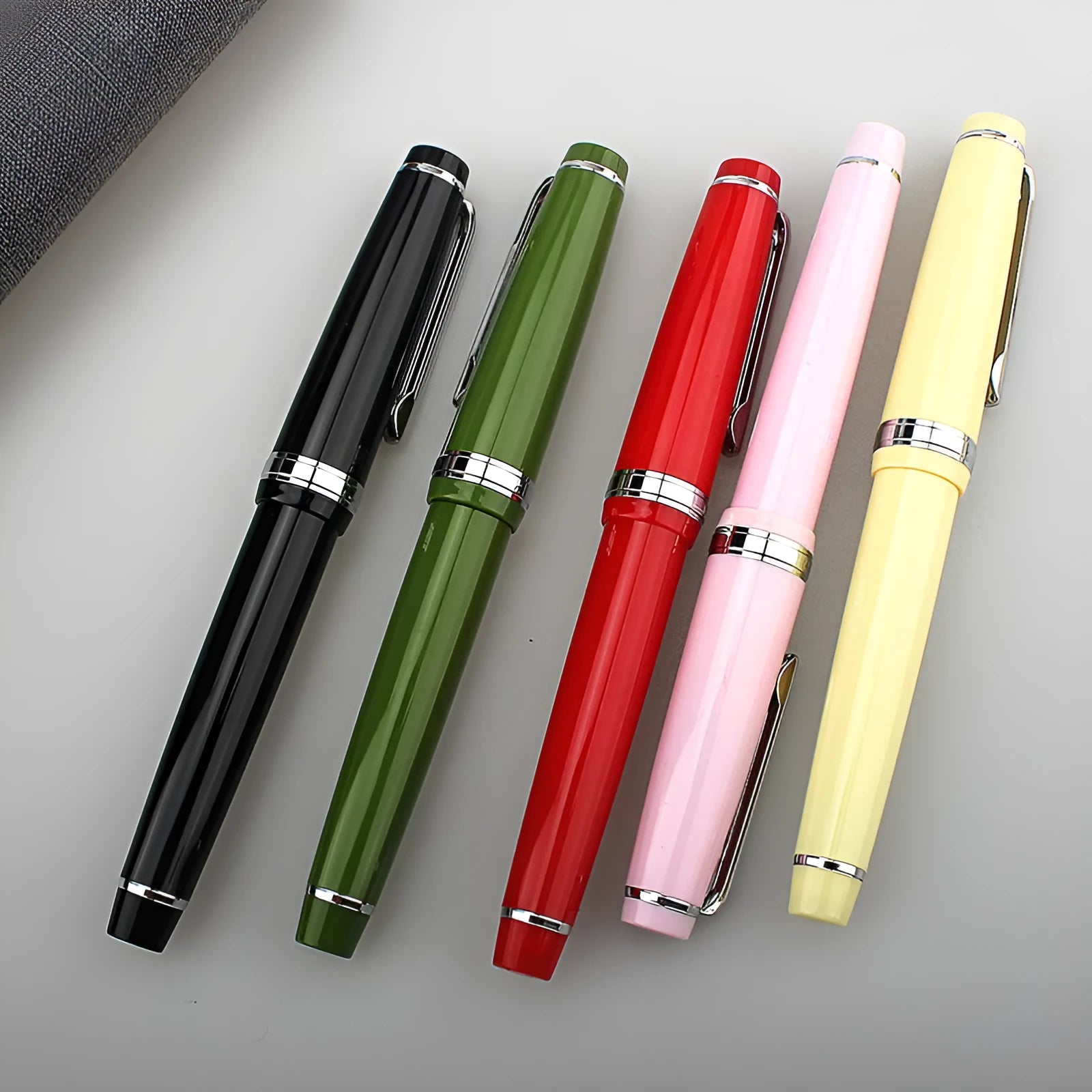 Resin business pen with stainless steel nib shown in a selection of colour and clip finish options.